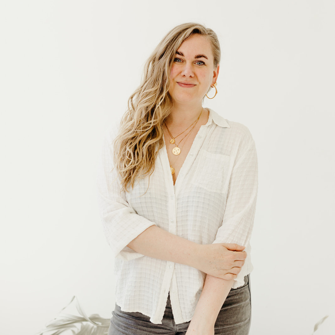 Magic Hour Podcast with Sarah Mulder Jewelry who designs jewelry in Vancouver, Canada. Photo of Sarah Mulder standing in front of a white wall