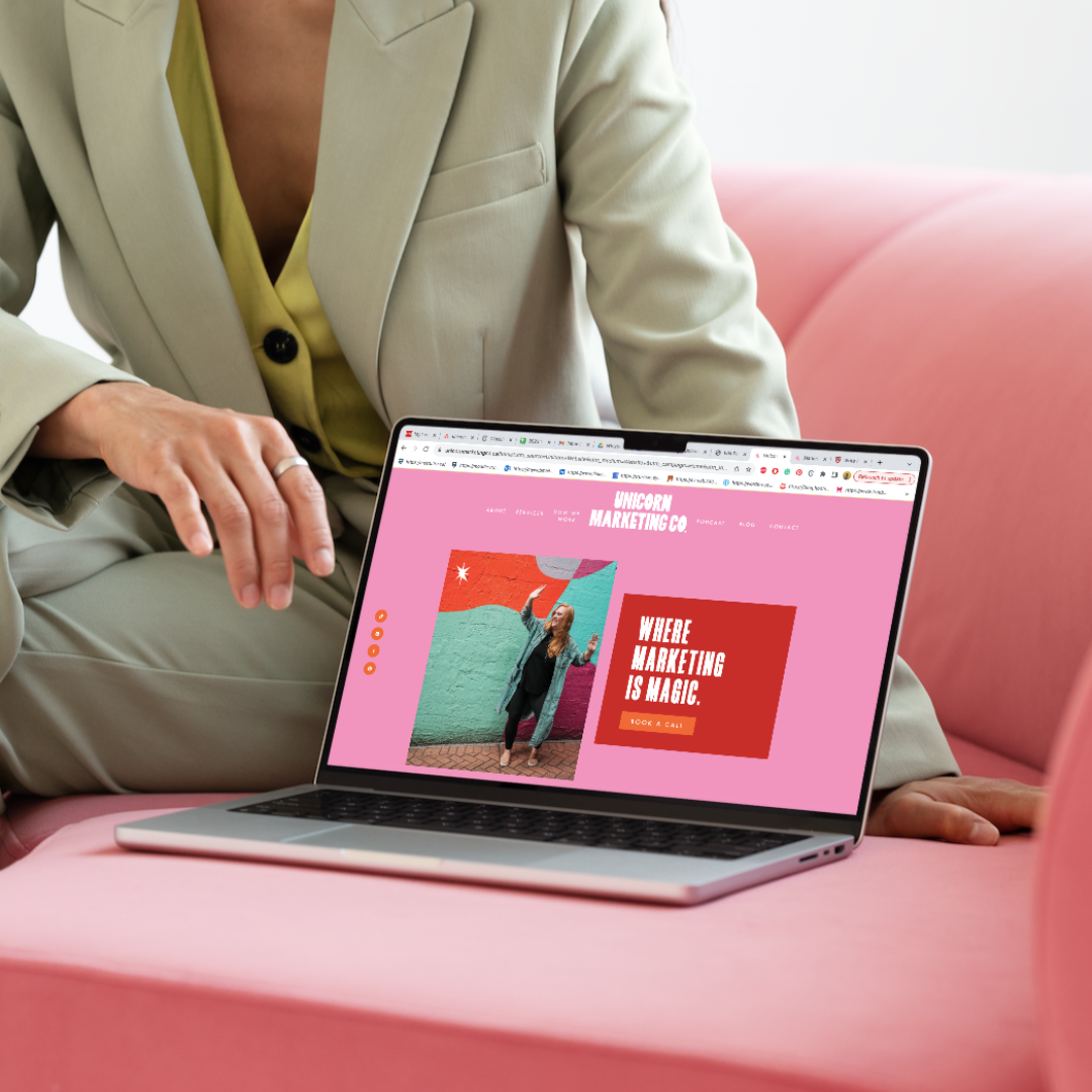Alt text blog. Girl in a green suit is sitting on a pink couch with a laptop that is showing the Unicorn Marketing Co.'s website that is talking about alt text and how it is important for SEO