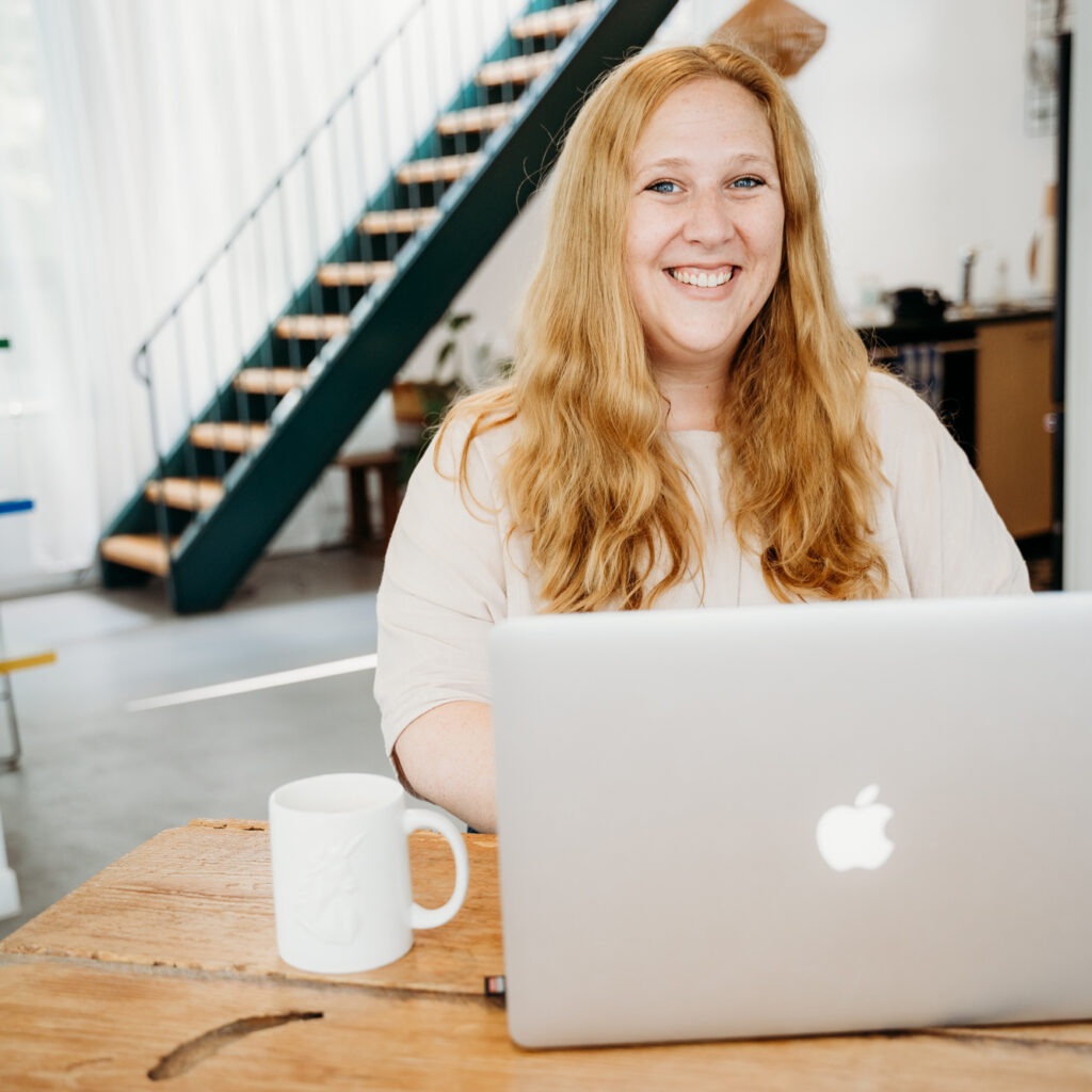 Founder and CEO of Unicorn Marketing Co, Hope Mikal. She is sitting at a computer about to record the Magic Hour Podcast season 1 roundup