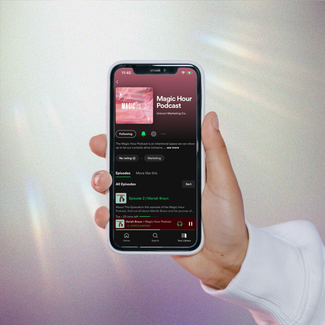 Girl holding a phone with the Season 1 of the Magic Hour Podcast playing on Spotify. Enjoy Season 1 of the Magic Hour Podcast!