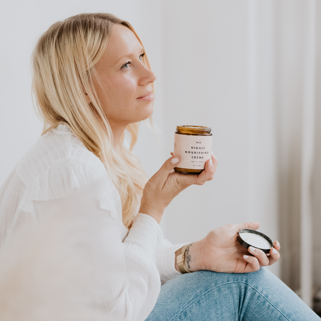Kelly Turner from You Deew You is sitting holding her jar of skincare