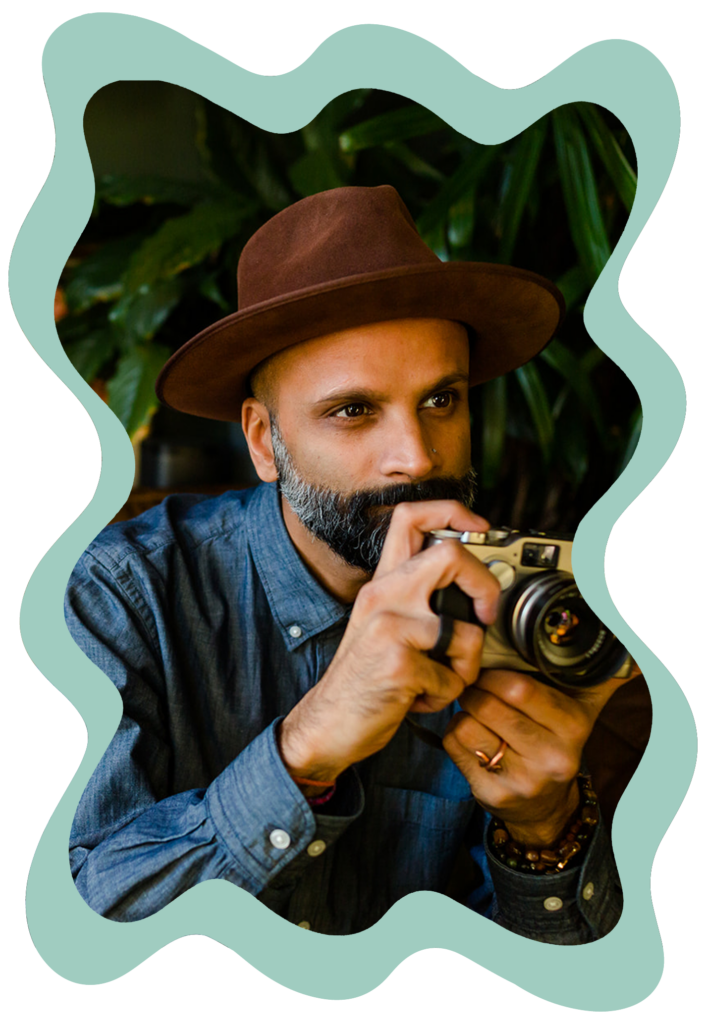 Sachin Khona with a camera posing for a photo