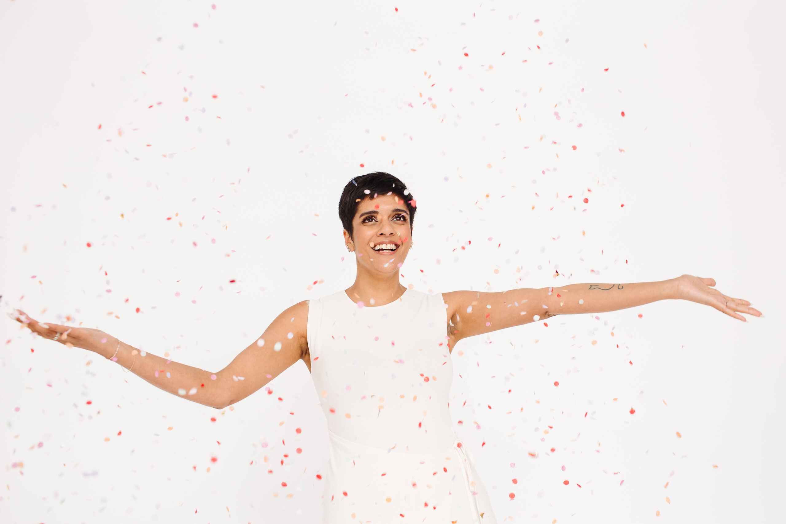 Radhika Graham from Rad Occasions is throwing confetti in the air